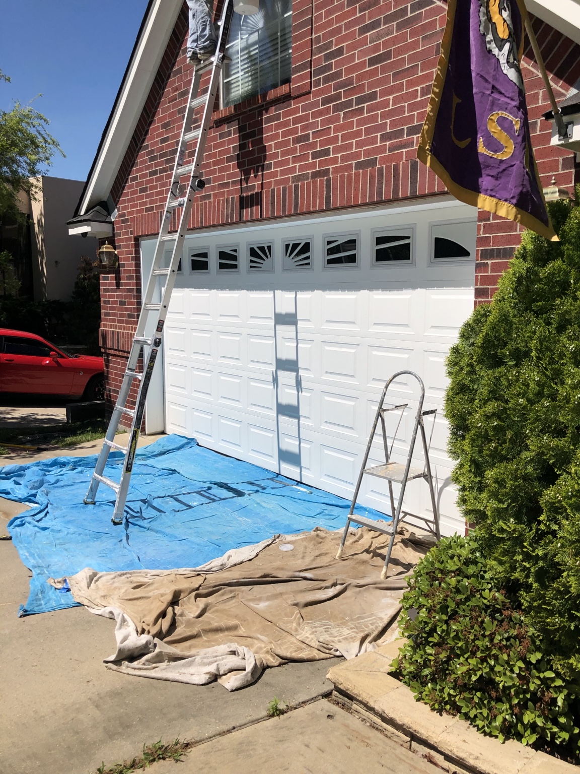 Brick home garage protected and prepared for exterior painting