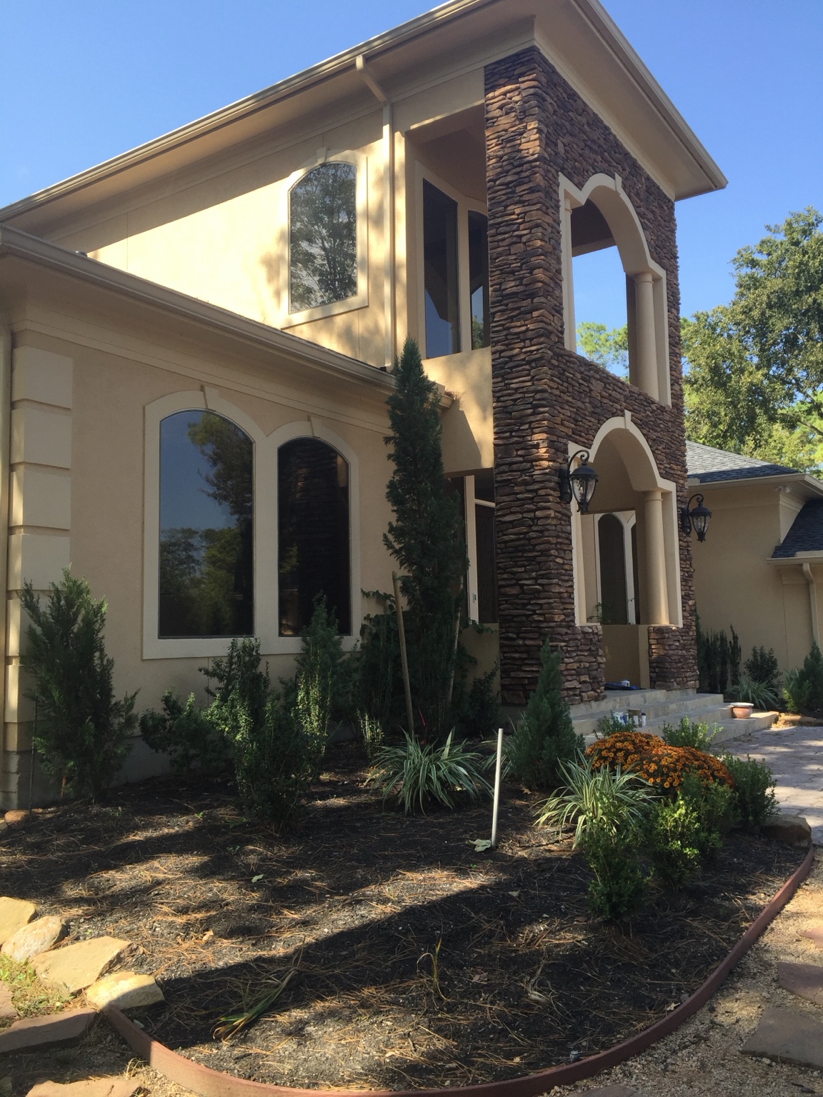 Large stucco and stone home exterior